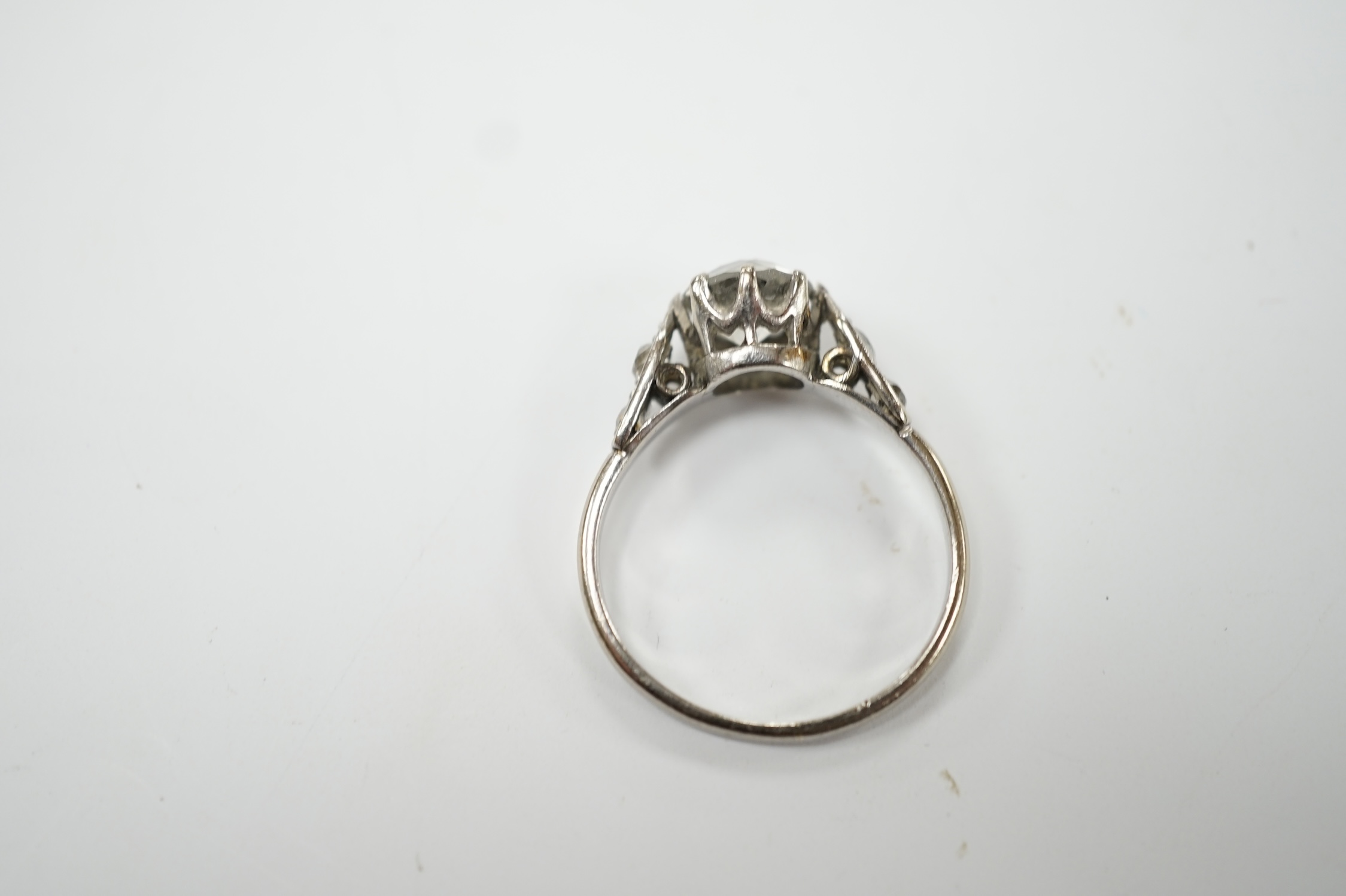 An 18ct, plat. and single stone diamond set ring, with four stone diamond set shoulders, size R/S, gross weight 3.4 grams. Poor condition.